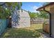 View of backyard shed with grass and wooden fence at 1925 Poinsetta Ln, Maitland, FL 32751