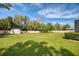 A large backyard with a shed features a tall wooden fence for privacy at 1984 Windermere Rd, Windermere, FL 34786