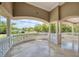 Large arched balcony with white railings overlooking the lush landscaped backyard at 1984 Windermere Rd, Windermere, FL 34786