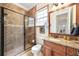 Beautiful bathroom featuring a glass-enclosed shower, tile surround, and granite vanity at 1984 Windermere Rd, Windermere, FL 34786