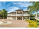Elegant two-story home featuring a grand facade, a circular driveway, and a beautifully landscaped yard at 1984 Windermere Rd, Windermere, FL 34786