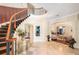 Grand foyer with curved staircase, elegant decor, and views into the living spaces at 1984 Windermere Rd, Windermere, FL 34786