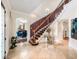 Elegant foyer with marble floors, staircase, and view into the formal dining room at 1984 Windermere Rd, Windermere, FL 34786