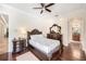 Spacious bedroom featuring hardwood floors, a ceiling fan, and a large mirror at 1984 Windermere Rd, Windermere, FL 34786