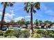 Charming shopping center view with lush landscaping, palm trees, and ample parking under a bright sky at 1984 Windermere Rd, Windermere, FL 34786