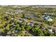 Wide aerial shot capturing this home within a neighborhood with tree-lined streets and green spaces at 2010 Overlook Dr, Winter Haven, FL 33884