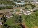 Aerial view showcasing a residential neighborhood with tree-lined streets and community features at 2010 Overlook Dr, Winter Haven, FL 33884