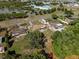 Aerial view showcasing a residential neighborhood with tree-lined streets and community features at 2010 Overlook Dr, Winter Haven, FL 33884