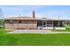 Home's brick exterior with brick patio and screened-in porch, set on a lush lawn at 2010 Overlook Dr, Winter Haven, FL 33884