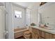 Vintage bathroom with wood cabinets, shower with curtain and traditional fixtures at 2010 Overlook Dr, Winter Haven, FL 33884