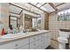 Retro bathroom with double vanity, floral wallpaper, and plenty of counter space at 2010 Overlook Dr, Winter Haven, FL 33884