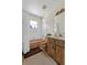 Vintage bathroom with wood cabinets, shower with curtain and traditional fixtures at 2010 Overlook Dr, Winter Haven, FL 33884