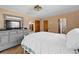 Spacious bedroom with a large bed, dresser, and a view into the hall at 2010 Overlook Dr, Winter Haven, FL 33884