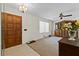 Welcoming entryway with tile floors, a wooden front door, and wooden furniture at 2010 Overlook Dr, Winter Haven, FL 33884