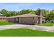 Exterior shot of home showcasing brick facade, tidy landscaping, and a well-maintained driveway at 2010 Overlook Dr, Winter Haven, FL 33884