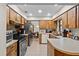 Functional kitchen with wood cabinets, stainless steel appliances, and ample counter space at 2010 Overlook Dr, Winter Haven, FL 33884