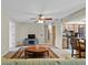 Cozy living room with ceiling fan, decorative rug, and view into the kitchen area at 2010 Overlook Dr, Winter Haven, FL 33884