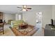 Bright living room with a ceiling fan, a decorative rug, and access to other rooms at 2010 Overlook Dr, Winter Haven, FL 33884