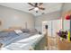 Bedroom featuring a ceiling fan, window and comfortable furniture at 2242 Dancy Trl, Clermont, FL 34714