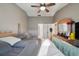 Bedroom features a ceiling fan, dresser with mirror, and a door leading to the bathroom at 2242 Dancy Trl, Clermont, FL 34714