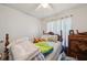 The bedroom has white walls, a ceiling fan, and a dresser at 2242 Dancy Trl, Clermont, FL 34714