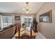 Inviting dining room with decorative chandelier, table, and natural light from sliding door at 2242 Dancy Trl, Clermont, FL 34714