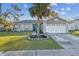 Charming single-story home with a well-manicured lawn and inviting blue front door at 2242 Dancy Trl, Clermont, FL 34714