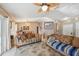 Comfortable living room with ceiling fan, with an adjacent dining area, perfect for entertaining at 2242 Dancy Trl, Clermont, FL 34714