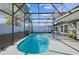 Clear, sparkling pool with a dark frame screen enclosure and an inviting curved edge at 2242 Dancy Trl, Clermont, FL 34714