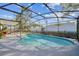 Sparkling pool with a curved edge, surrounded by a large screened enclosure at 2242 Dancy Trl, Clermont, FL 34714