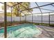 Inviting screened-in pool with clear blue water, surrounded by a well-maintained deck and a white privacy fence at 2242 Dancy Trl, Clermont, FL 34714