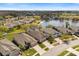 Aerial view of a neighborhood featuring homes surrounding a lake, showcasing community layout at 2315 Cypress Trace Cir, Orlando, FL 32825