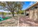 Backyard featuring a brick patio, playground, white picket fence, and lake at 2315 Cypress Trace Cir, Orlando, FL 32825