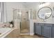 Bathroom with gray vanity, round mirror and glass shower at 2315 Cypress Trace Cir, Orlando, FL 32825