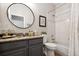 Well-lit bathroom featuring a granite vanity, mirror, and shower with curtain at 2315 Cypress Trace Cir, Orlando, FL 32825