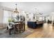 Stylish kitchen with a dark center island, pendant lighting, stainless steel appliances, and hardwood floors at 2315 Cypress Trace Cir, Orlando, FL 32825