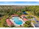 Beautiful community pool area with palm trees, covered seating, and lounge chairs at 2315 Cypress Trace Cir, Orlando, FL 32825