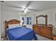 Cozy bedroom features wood furniture, a ceiling fan, a window providing lots of natural light and soft colors at 2381 Roxbury Rd, Winter Park, FL 32789