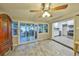 Bright dining area with adjacent screened porch access and a view of the modern kitchen at 2381 Roxbury Rd, Winter Park, FL 32789