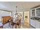 Bright dining room with built-in shelving and access to living room with fireplace at 2381 Roxbury Rd, Winter Park, FL 32789