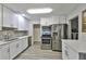 Modern kitchen featuring stainless steel appliances, light cabinets, and quartz countertops at 2381 Roxbury Rd, Winter Park, FL 32789