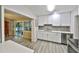 Bright kitchen with stone backsplash, stainless steel appliances and a view of the dining area at 2381 Roxbury Rd, Winter Park, FL 32789