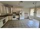 Open concept kitchen featuring white cabinets and appliances with tile flooring at 2625 Queen Mary Pl, Maitland, FL 32751