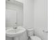 Powder room featuring white vanity and modern fixtures at 312 Castle Dr, Lake Alfred, FL 33850