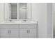 Bright bathroom features double sinks and shaker style cabinets at 312 Castle Dr, Lake Alfred, FL 33850