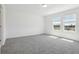 Bedroom features neutral paint, plush carpet, natural light and views at 312 Castle Dr, Lake Alfred, FL 33850