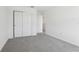 Bedroom features sliding closet doors and neutral carpeting at 312 Castle Dr, Lake Alfred, FL 33850