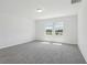 Bedroom features neutral paint, plush carpet, natural light and views at 312 Castle Dr, Lake Alfred, FL 33850