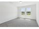 Bedroom features neutral paint, plush carpet, natural light and views at 312 Castle Dr, Lake Alfred, FL 33850