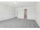 Bedroom features neutral paint and plush carpet at 312 Castle Dr, Lake Alfred, FL 33850